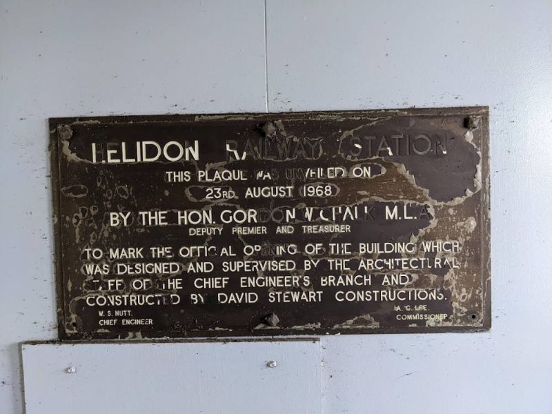 HELIDON RAILWAY STATION
THIS PLAQUE WAS UNVAILED ON
23RD AUGUST 1968

BY THE HON. GORDON W. CHALK M.L.A.
DEPUTY PREMIER AND TREASURER

TO MARK THE OFFICIAL OPENING OF THE BUILDING WHICH
WAS DESIGNED AND SUPERVISED BY THE ARCHITECTURAL
STAFF OF THE CHIEF ENGINEER’S BRANCH AND
CONSTRUCTED BY DAVID STEWART CONSTRUCTIONS.
W.S.NUTT A.C.LEE
CHIEF ENGINEER COMMISSIONER
